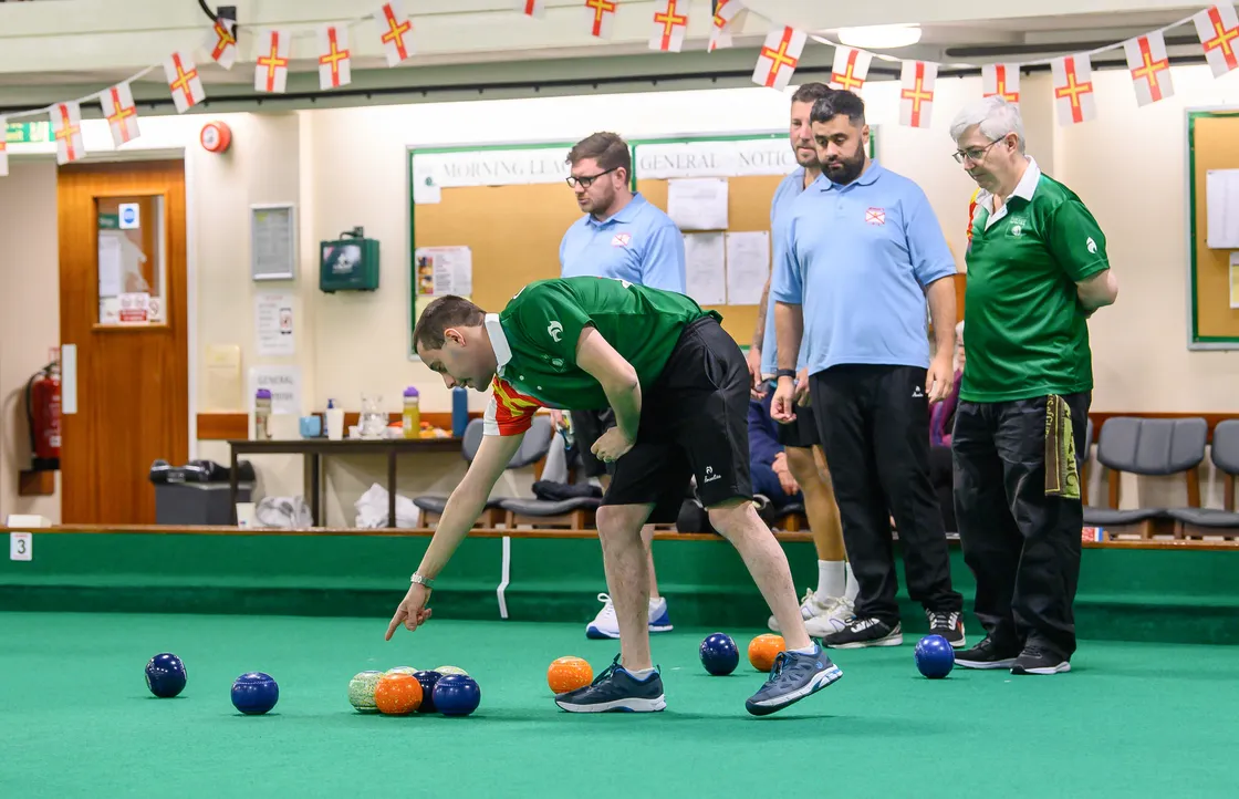 Josh Bonsall passes on some information to his skip Ian Merrien in the men’s triples final