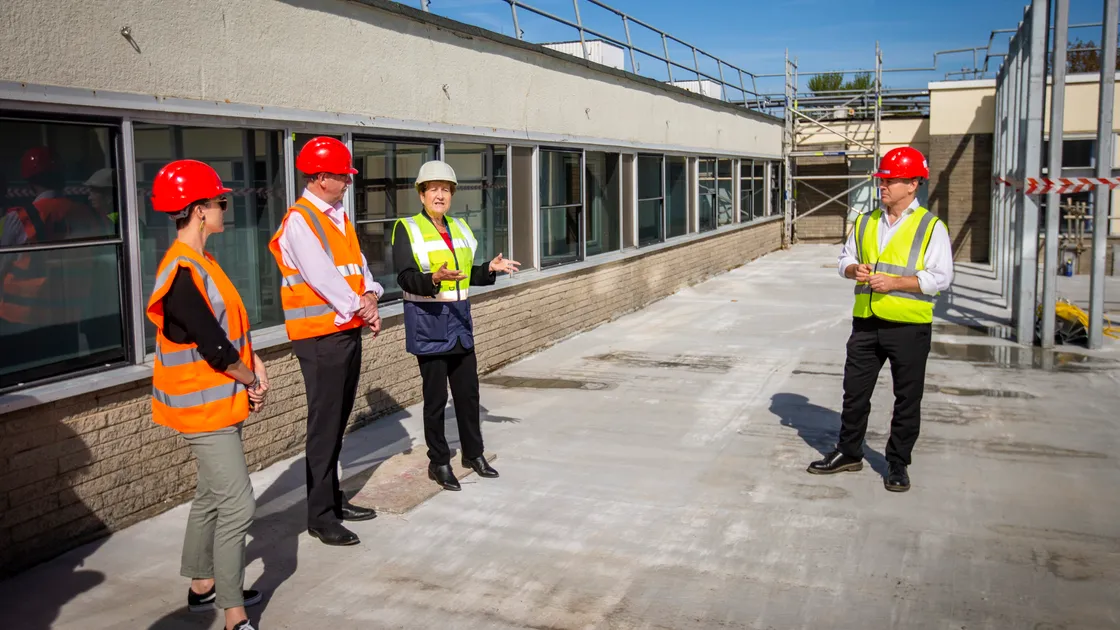 Hospital modernisation director Jan Coleman, second right, explaining the work done on phase one at a topping out ceremony. Listening left to right, are Health & Social care vice-president Deputy Tina Bury, president Deputy Al Brouard and Gavin Rihoy, chairman of Rihoy & Son. (Picture by Sophie Rabey, 32069109)