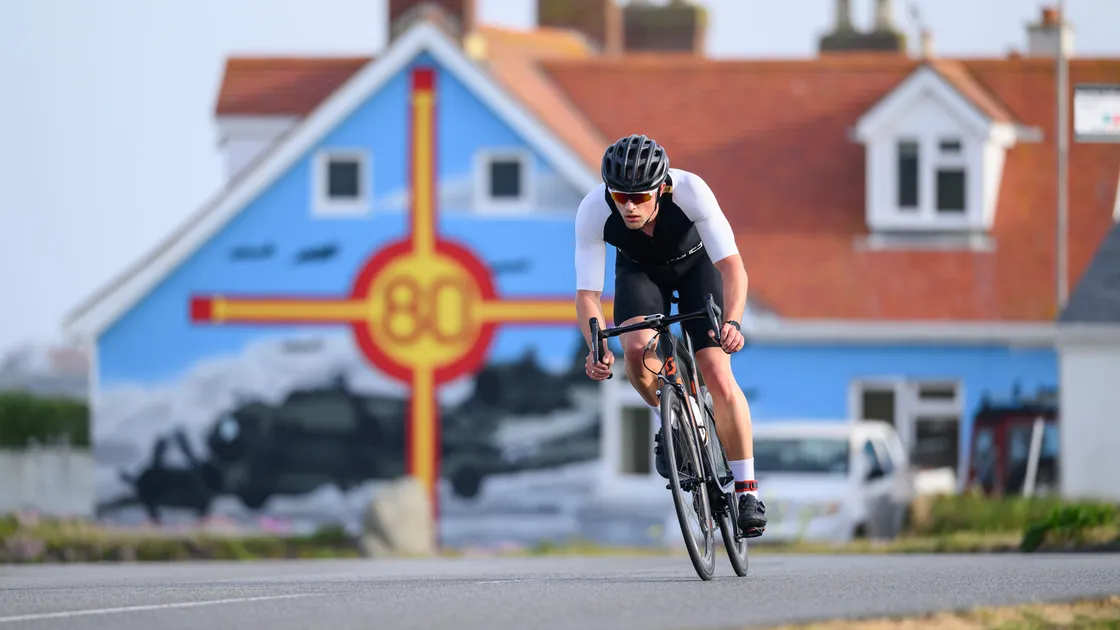 Winner Louis Le Cheminant passes the iconic Liberation Day mural at L'Eree.
