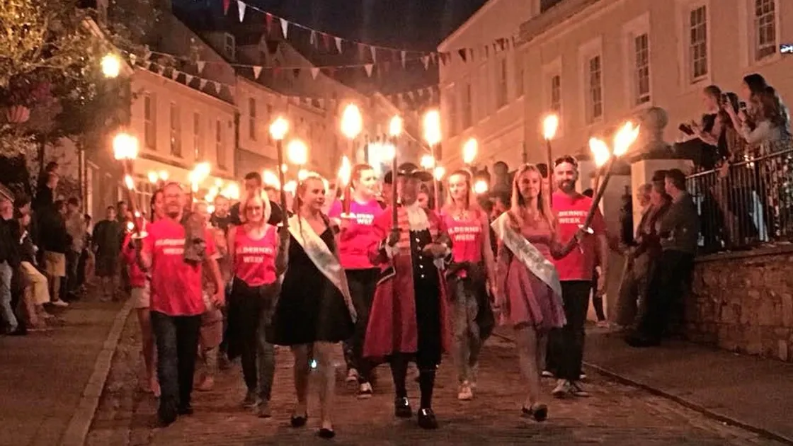 The Torchlight Procession ending the 70th anniversary of Alderney Week led by Miss Alderney Poppy Taylor and Town Crier Robin Whicker in Victoria Street.
(Picture by Ilona Soane-Sands)