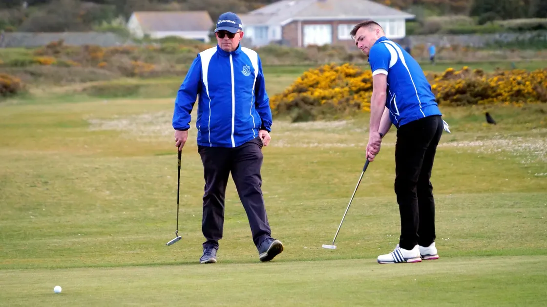 Sam Le Huray putts watched by playing partner Arthur Evans. (Picture by Gareth Le Prevost, 29535070)