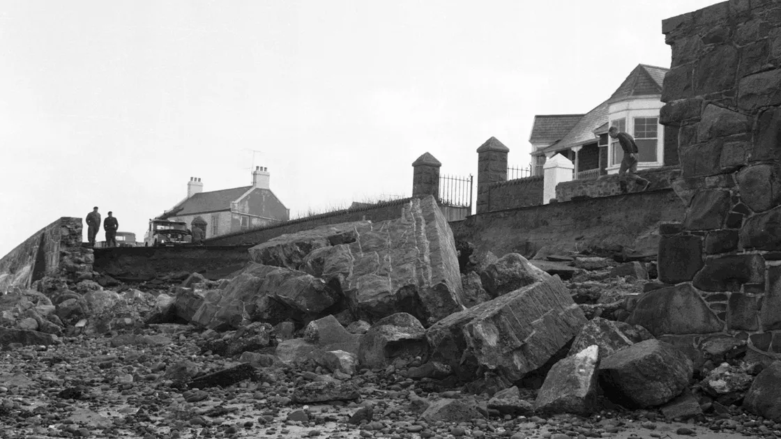 The roadway and front gardens of properties were washed away after the Cobo Bay seawall collapsed.