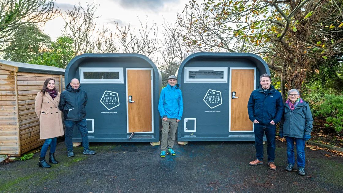 The Caritas team, left to right, Molly Edington, Phil Roussel, Graham Merfield, the Rev. Daniel Foot and Sandra Crittell next to the two new sleeping pods