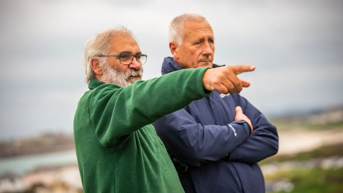National Trust of Guernsey president Mike Brown, left, points out the views to properties manager Jim Whitmore.. (31425462)