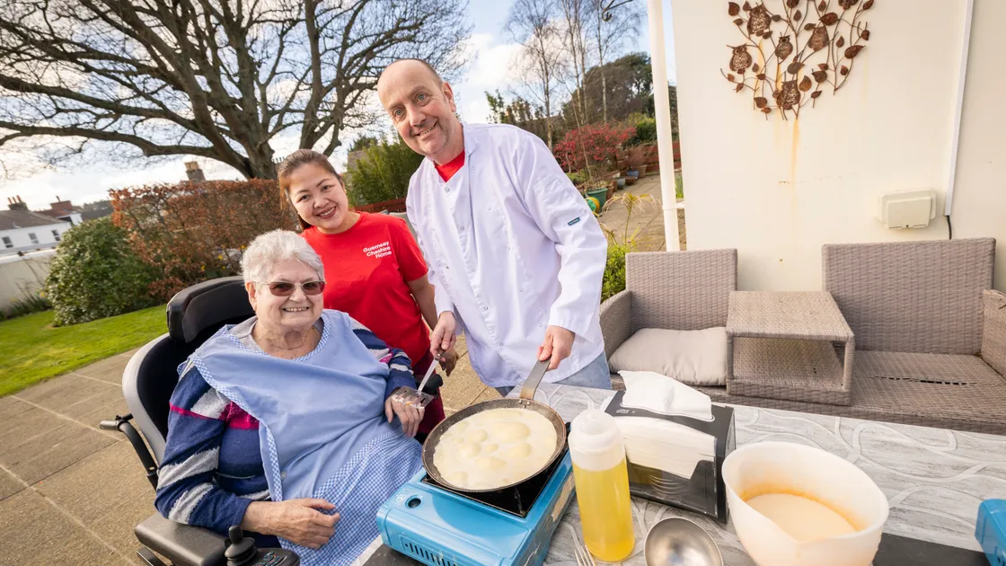 Left to right, home resident June Ceillam, carer Judy Angeles and carer Jim Ozanne practising his pancake skills. (Picture by Sophie Rabey, 34061040)