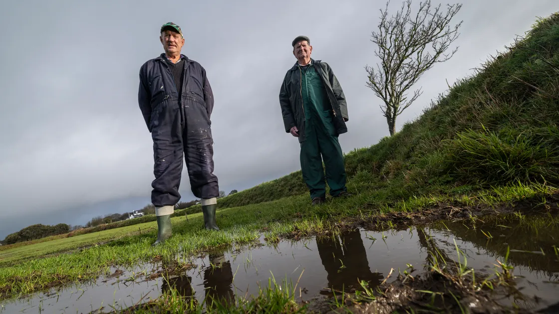 Kevin Smith, left, and Tom Bougourd in a field in Torteval where they found bags of fly-tipped rubbish