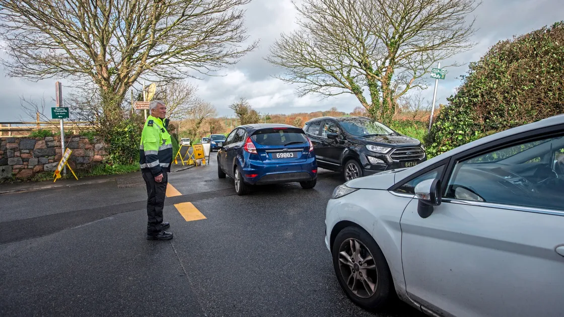 Civil Protection volunteers were called in to assist in directing the traffic after part of a conifer tree, inset, fell in high winds on the diversion route during the closure of Le Bourg. (Pictures by Peter Frankland, 32994151)