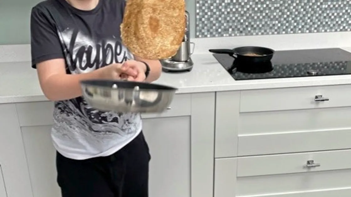 La Houguette Primary School year 5 student Matthew Adkins flipping pancakes at home, who said: 'Pancakes are really fun to eat; pancakes are a great treat!' Image supplied by La Houguette. (29249230)