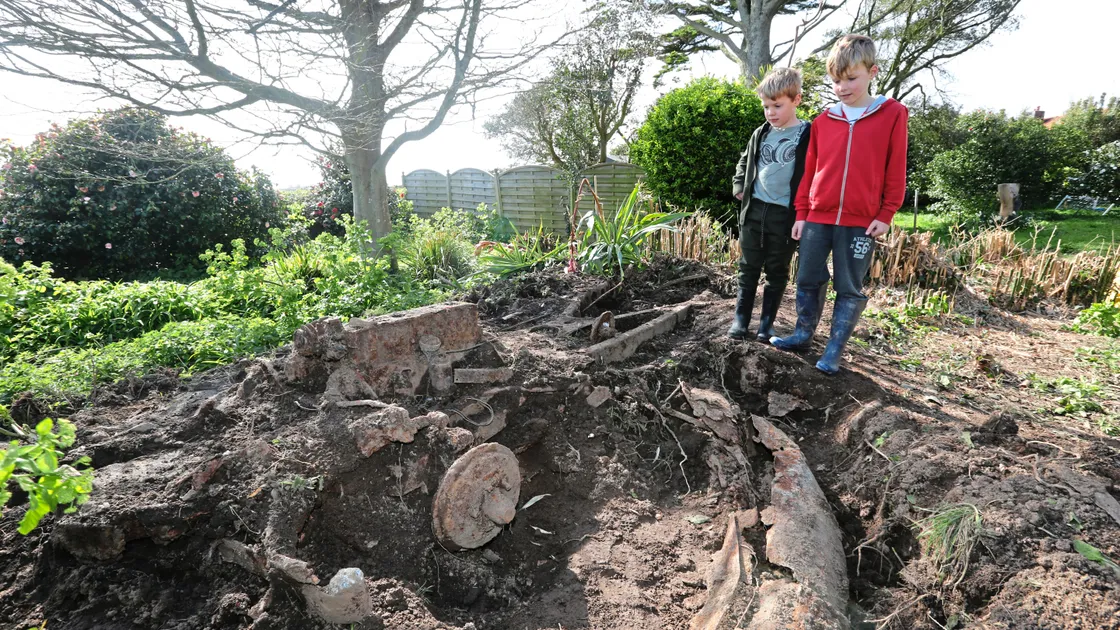 Brothers Jake Ward, 6, left, and Joe, 9, with the vintage Daimler which was found when their parents and grandparents were clearing the garden. The parents bought the home in Rue du Felconte, St Peter’s, in November and had set about clearing the garden of weeds.
(Pictures by Adrian Miller, 21107448)