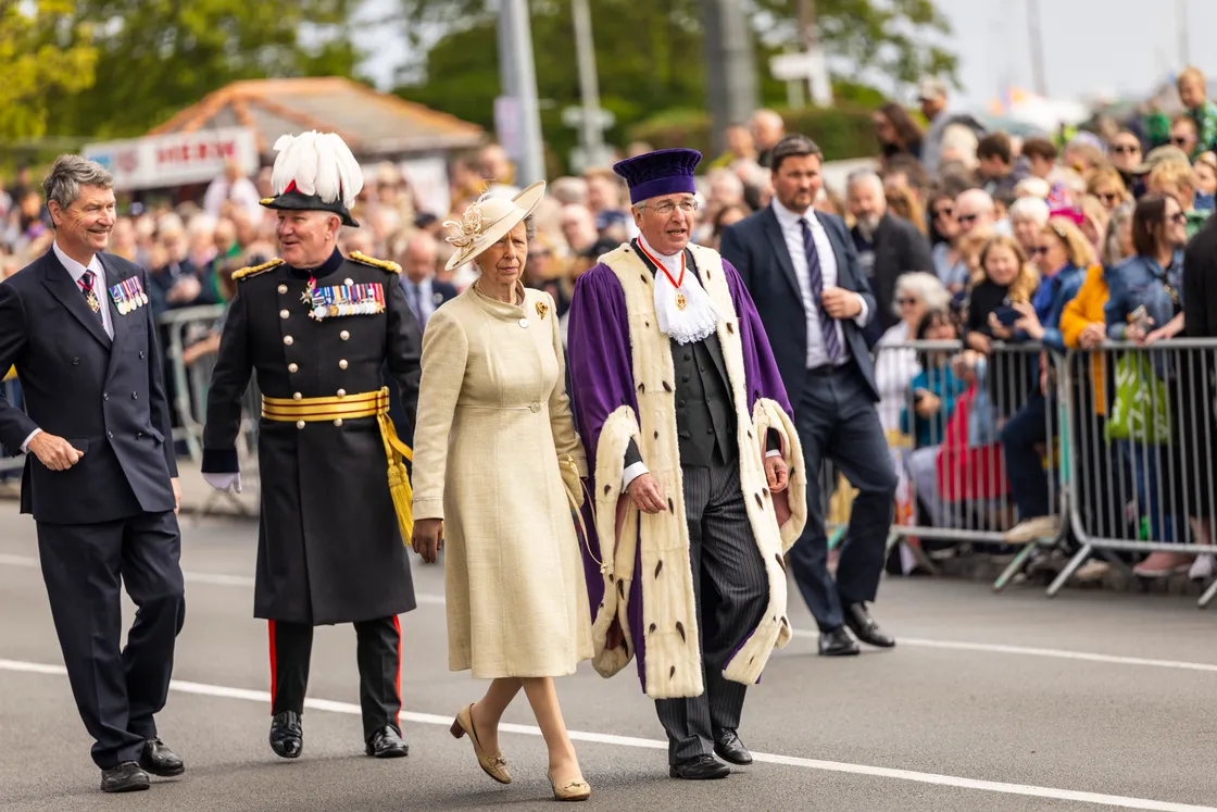 Sir Richard accompanies the Princess Royal during the 80th Liberation Day celebrations last year