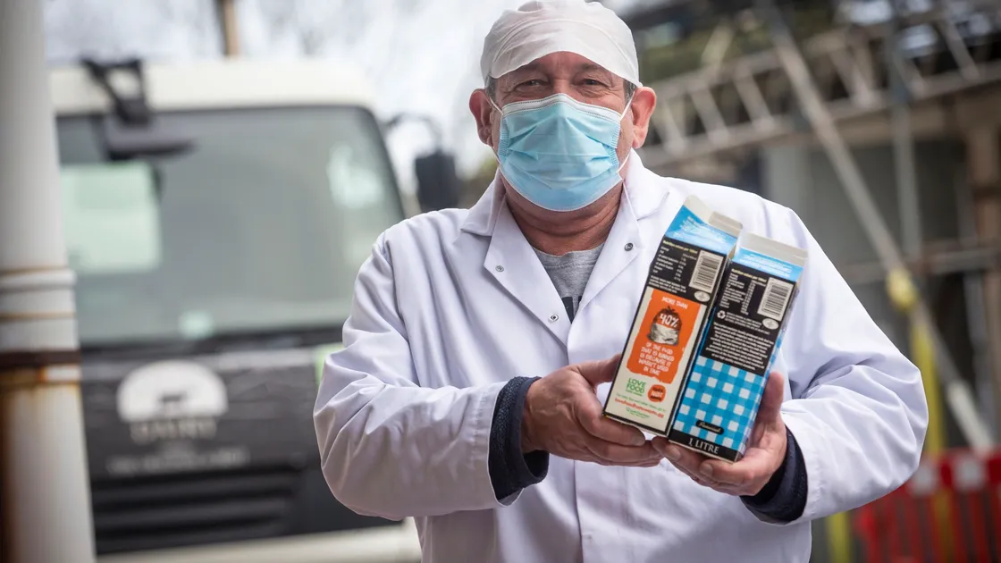 Guernsey Dairy production manager Dave Domaille with one of the milk cartons it has held in reserve which are being used. (Picture by Peter Frankland, 30383281)