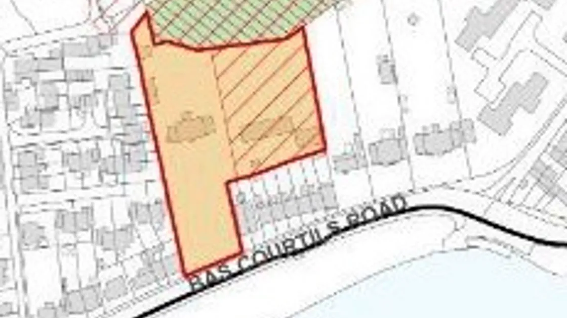 Extract from the IDP Proposals Map showing the Les Bas Courtils housing allocation site outlined in bold.