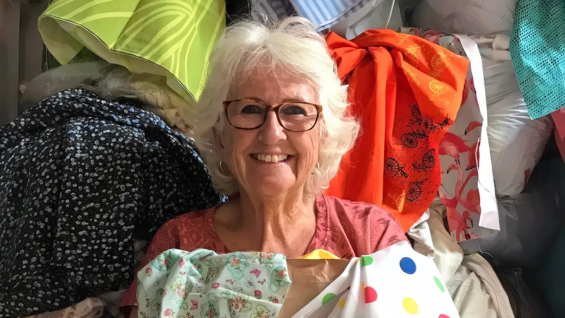 Liberation Day bunting project organiser Megs Bailey with donated bunting material. (Picture supplied)