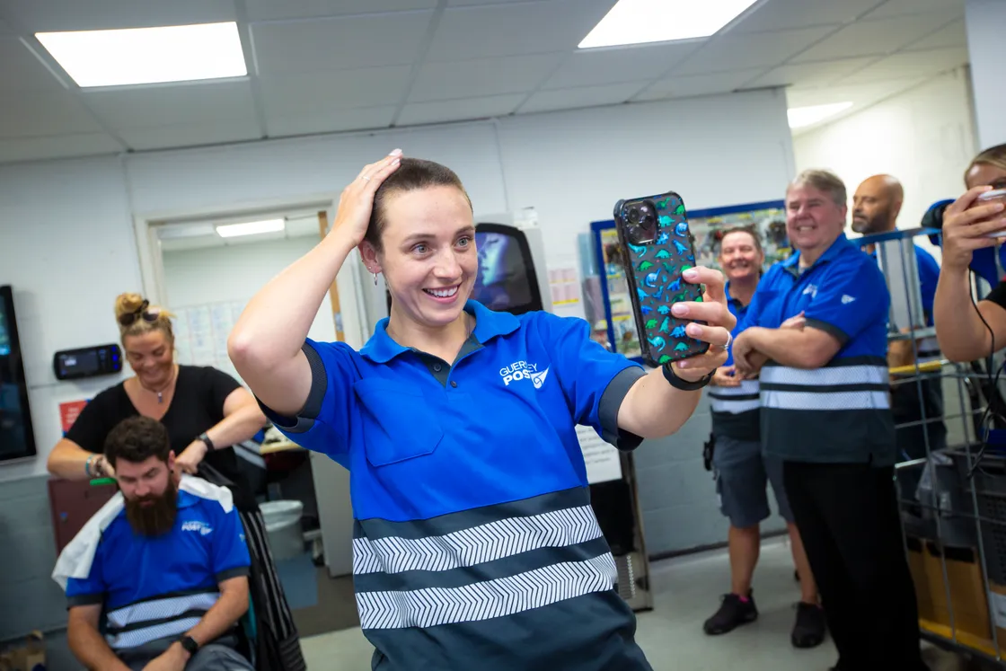 Tyler admires her new hairstyle, while on the right, one of her four colleagues is about to have his head shaved.   (31191295)
