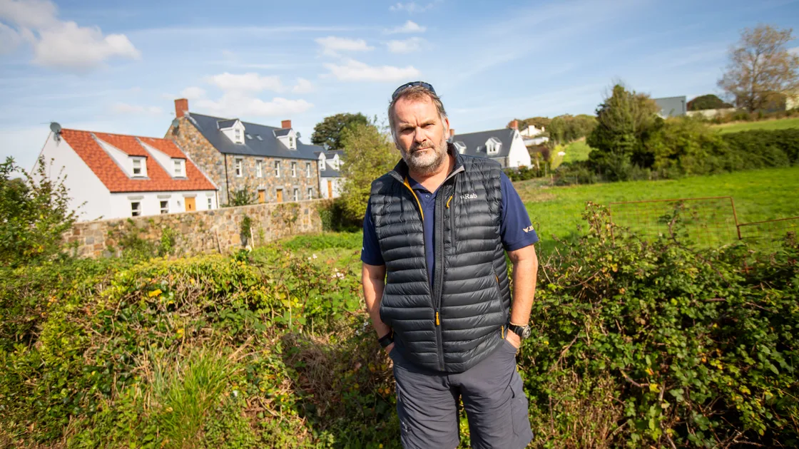 Bomb disposal expert Ben Remfrey pictured in 2024 at the suspected location of three unexploded WW2 bombs in Route Isabelle, opposite Le Foulon Cemetery.