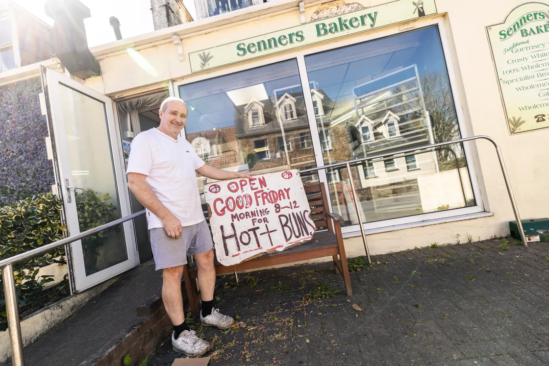 Martin Senner with his father Brian's old Hot Cross Buns sign.