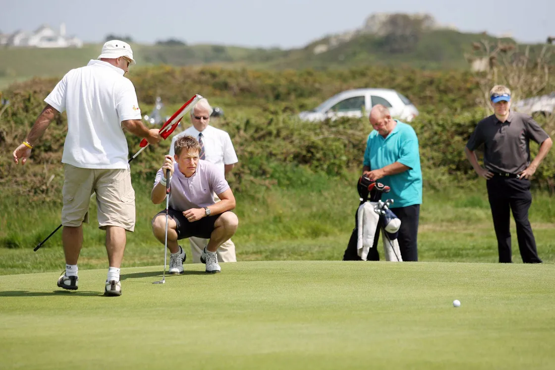Steve Mahy lines up a putt in the 2007 Hampshire Men’s County Championship final at L’Ancresse, watched by opponent and eventual champion Ryan Henley.