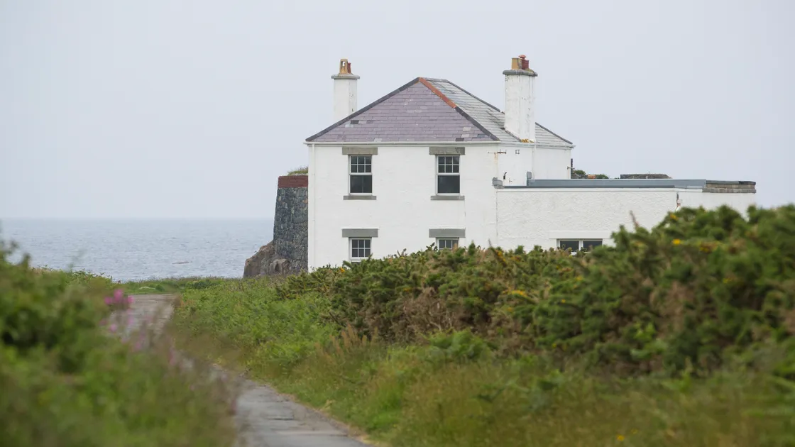 The private sale of the former Platte Fougere lighthouse station and store has prompted questions from Vale deputy Neil Inder, inset.(Picture by Peter Frankland, 21806354)