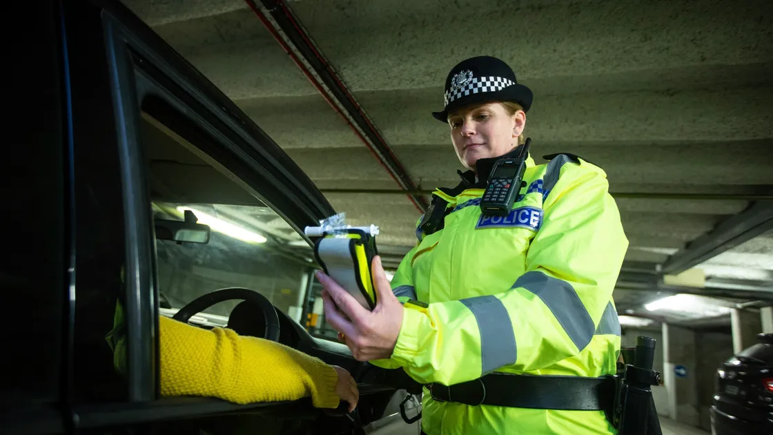 Student officer Jeanine Taylor pulls over Guernsey Press reporter Emily Hubert in a drink-drive test training exercise. (Picture by Peter Frankland, 29026648)