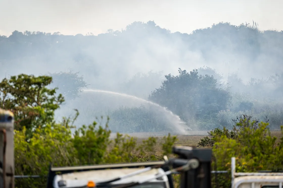 ‘Due to current wind conditions, there remains a risk of the fire reigniting in places and crews will continue to monitor the area closely,’ said a spokesman.