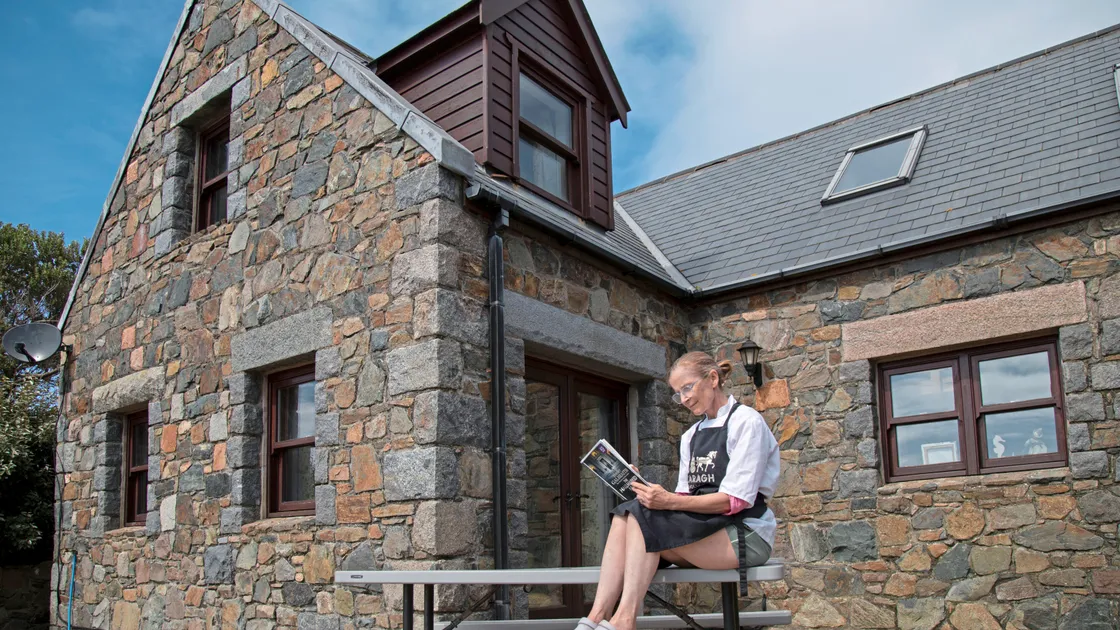 Caragh Couldridge, owner of the Old Forge on Sark gets a first look at how her cottage features in the latest book by J K Rowling