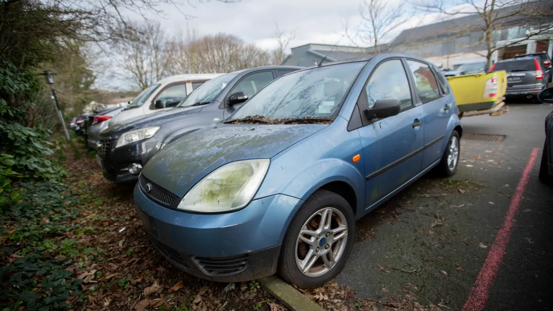One of the vehicles due to be moved is this Ford Fiesta near the Emergency Department. Its insurance disc ran out in 2021 and it has a covering of moss. (Picture by Luke Le Prevost, 31726165)