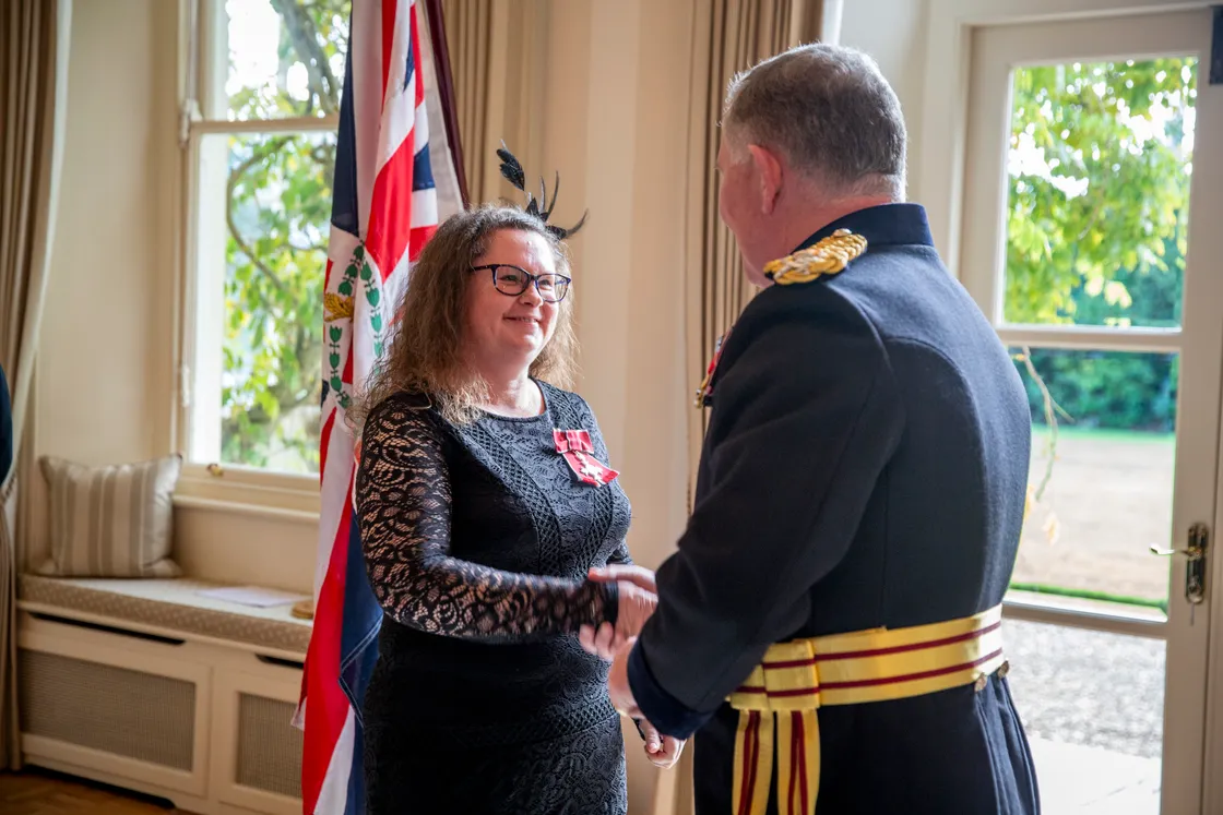 Lucy Beere shakes the Lt-Governor's hand after being presented with her MBE medal at Government House. (Picture by Luke Le Prevost, 32768705)