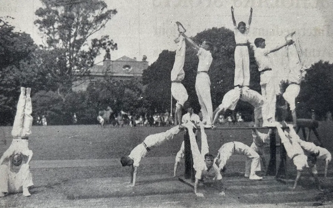 Beau Sejour house hovers in the background as the Boys' Intermediate stage a sports day tableau in the 1930s