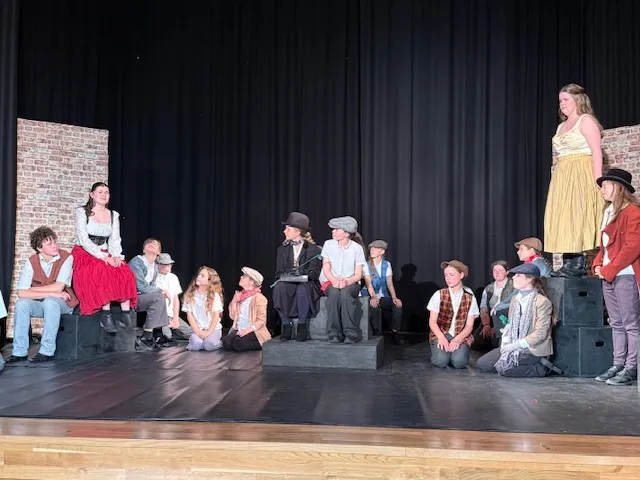 Erin Cullwick (second left) as Nancy singing It’s A Fine Life