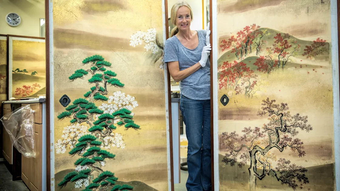 Paper conservator Lisa Oxenden-Wray with the 19th century Japanese screens. (Picture by Peter Frankland, 22464137)