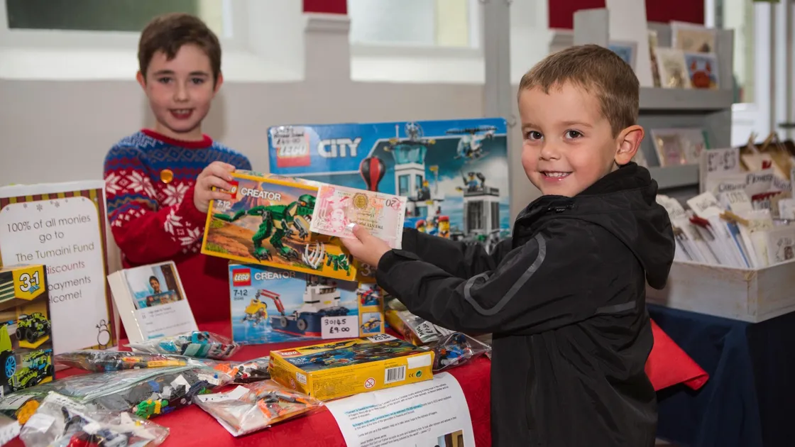 Nicolas Lenfesty, 8, found an eager buyer in four-year-old Noah Tardivel when he used the Blanchelande College Christmas Fayre to sell part of his Lego collection with the proceeds going to the Tumaini Fund, the local charity which works with Aids widows and orphans in Tanzania. (Picture by Stacey Upson)