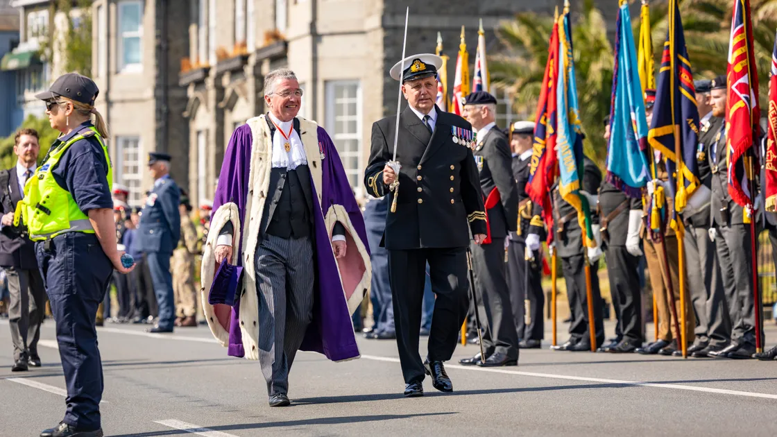 Sir Richard McMahon, pictured at the Liberation Day 2026 parade on Saturday, alongside Liberation Day parade commander Tim Slann, has announced his intention to officially step down as Bailiff at the end of August. 			 (Picture by Sophie Rabey, 34744992)