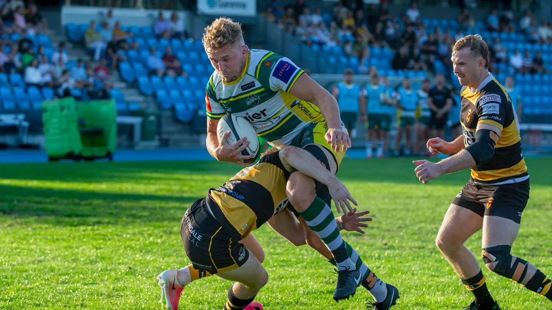Guernsey No 8 Josh Poullet carries the ball into contact close to the line.