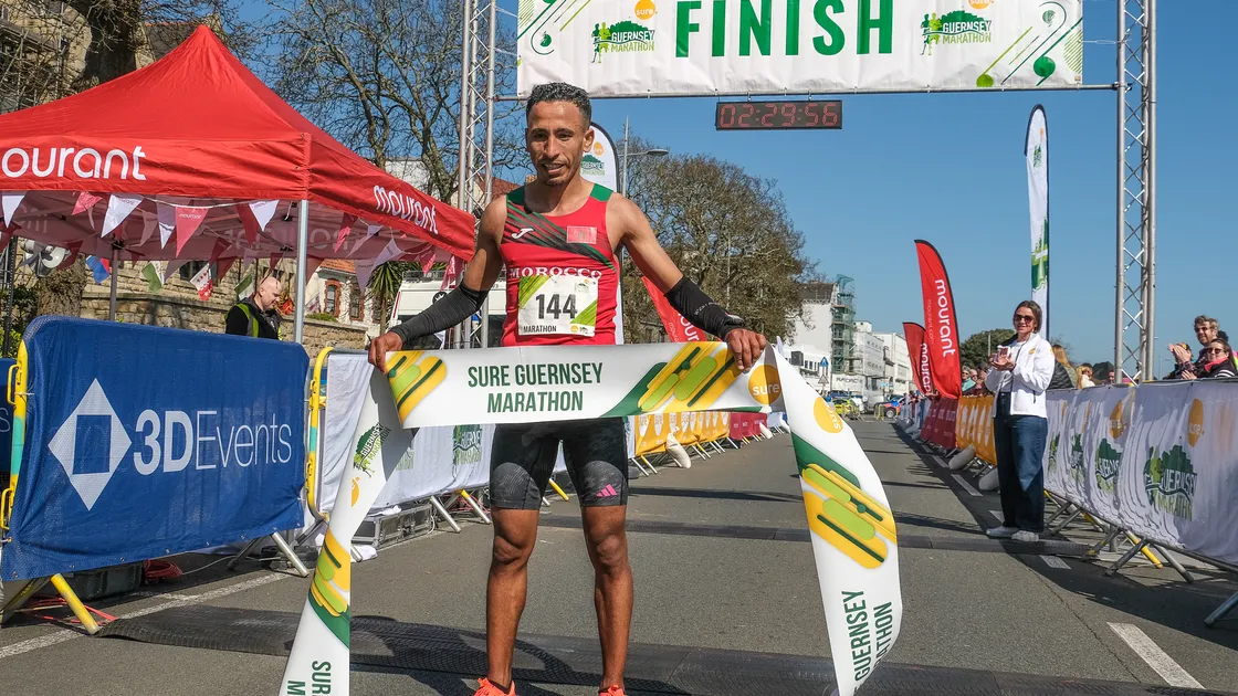 Morocco's Otmane Menbar set a new course record of 2hr 29min. 48sec. in winning yesterday's Sure Guernsey Marathon.