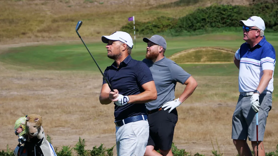 Steve Mahy tees off at the eight watched by playing partners Tom Le Huray and Dave Jeffery, the Island men's team captain. (Picture by Gareth Le Prevost, 31120937)