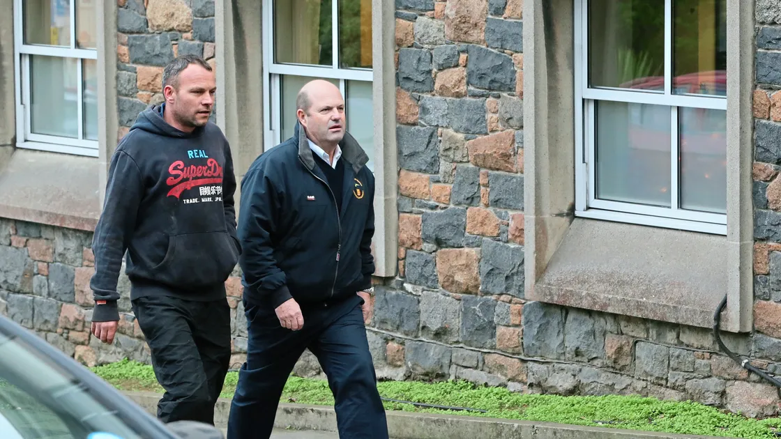 Gary Robson, left, from Dumfries on his way to the Magistrate’s Court where he admitted fishing illegally by using more scallop dredges than his licence allowed. He is accompanied by sea fishers officer Michael Phillips.(Picture by Adrian Miller, 20093394)