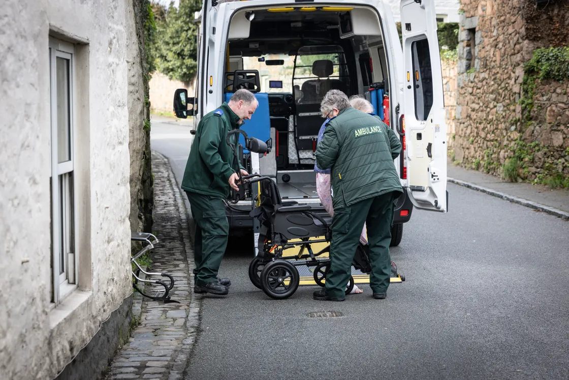 Nicky and Dave help a patient into the ambulance.