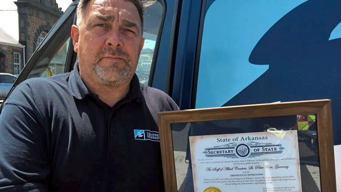 Ships agency manager Iain Phillips with the Certificate of Appreciation from the State of Arkansas for helping one of its residents after she broke her arm and had to be taken back to the US. 									                                            (22059759)