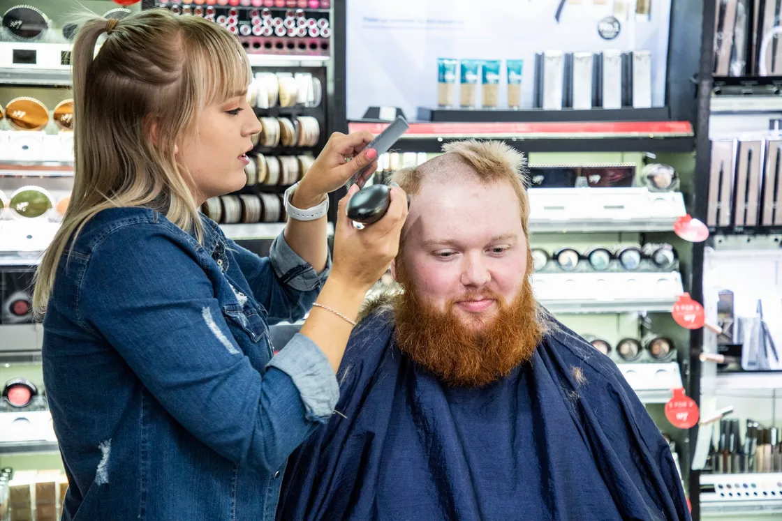 Picture by Sophie Rabey.  04-09-20.  Boots Charity Event Sponsored by All Beauty..The staff in store will be raising money for their chosen local charities buy opting to do a head/beard shave or leg/chest waxing..Courtney Le Moigne from All Beauty who is cutting Gareth Davies hair and beard to raise money for MUG.. (28653429)