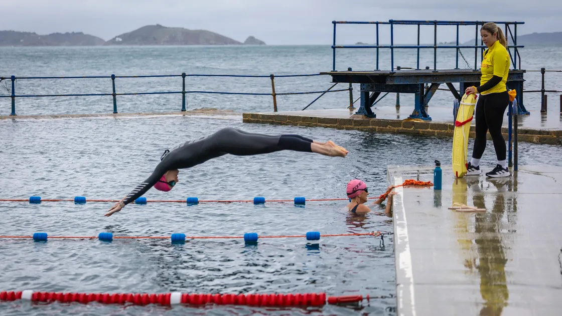 The Salty Swimarathon gets under way for the first time at La Vallette Bathing Pools yesterday morning. Marielle Fritsch takes over from Jo Huxtable for team Deloitte. 			 (Picture by Peter Frankland, 34971328)