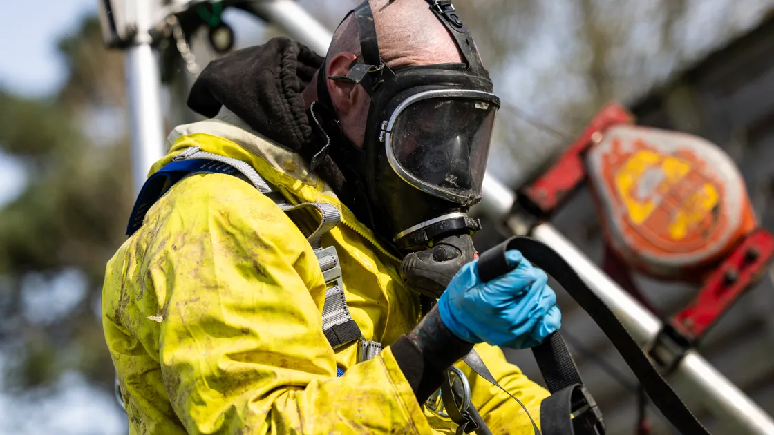 Before going down the hole, workers have to protect themselves with the proper gear and attire, which includes an overall suit, helmet and face mask