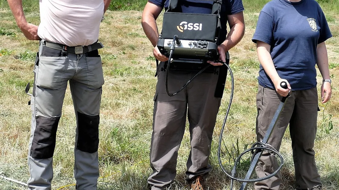 Andy Lane, left, Dr Rob Fry and Louise Randell, with the ground penetrating radar kit on Longis Common. (Picture by David Nash)