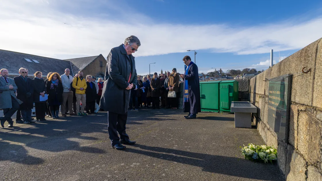 Bailiff Sir Richard McMahon laid a wreath at the memorial for foreign workers