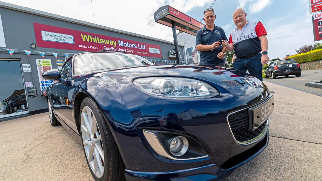 Ian Ogier, right, being handed the keys to the car by Andre Whiteway of Whiteway Motors.