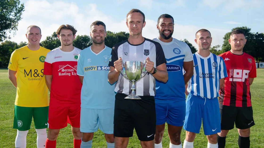 Senior representatives of the seven Guernsey FNB Priaulx League clubs with the prize at stake ahead of the new season, which starts today. Alderney Nomads will also compete for the title. Left to right: Glenn Le Tissier (Vale Rec), James Ravenscroft (Sylvans), River Marsh (Northerners), Chris Le Noury (St Martin’s), Tobi Oluborode (Rovers), Steve Saunders (Belgrave Wanderers) and Joe Clatworthy (Rangers). (Picture by Andrew Le Poidevin, 31186038)