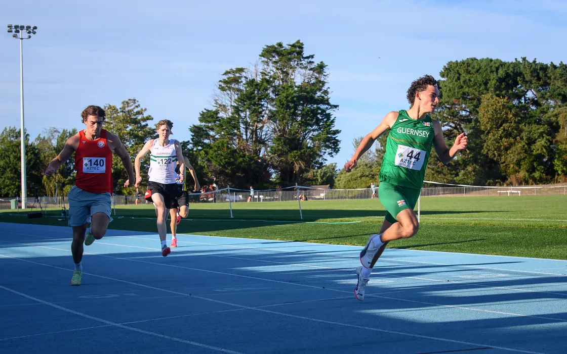 Theo Le Tissier winning his 100m race ahead of visiting sprinter Luke Martin from Invicta East Kent AC.