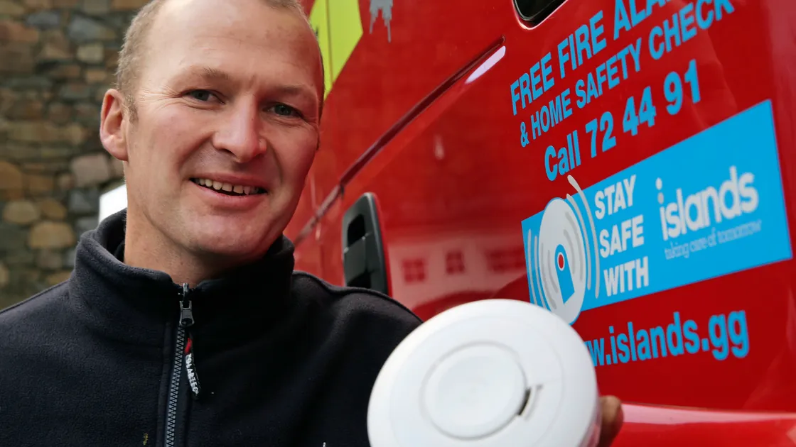 Firefighter Grant Hutchins with a smoke alarm, which have been fitted in local homes as part of the Fire and Rescue Service’s free fire safety risk assessments.              (Picture by Peter Frankland, 20169326)