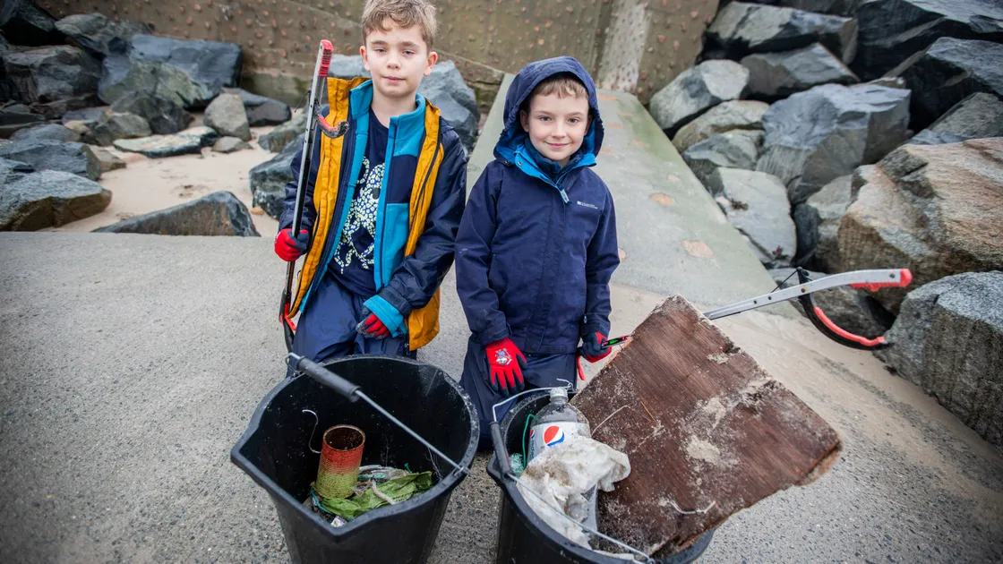 Brothers Luke, left, and James Harvey, aged 11 and 8, at Grandes Rocques where the Clean Earth Trust held its first beach clean of 2023 on New Year’s Day. (Pictures by Luke Le Prevost, 31629795)