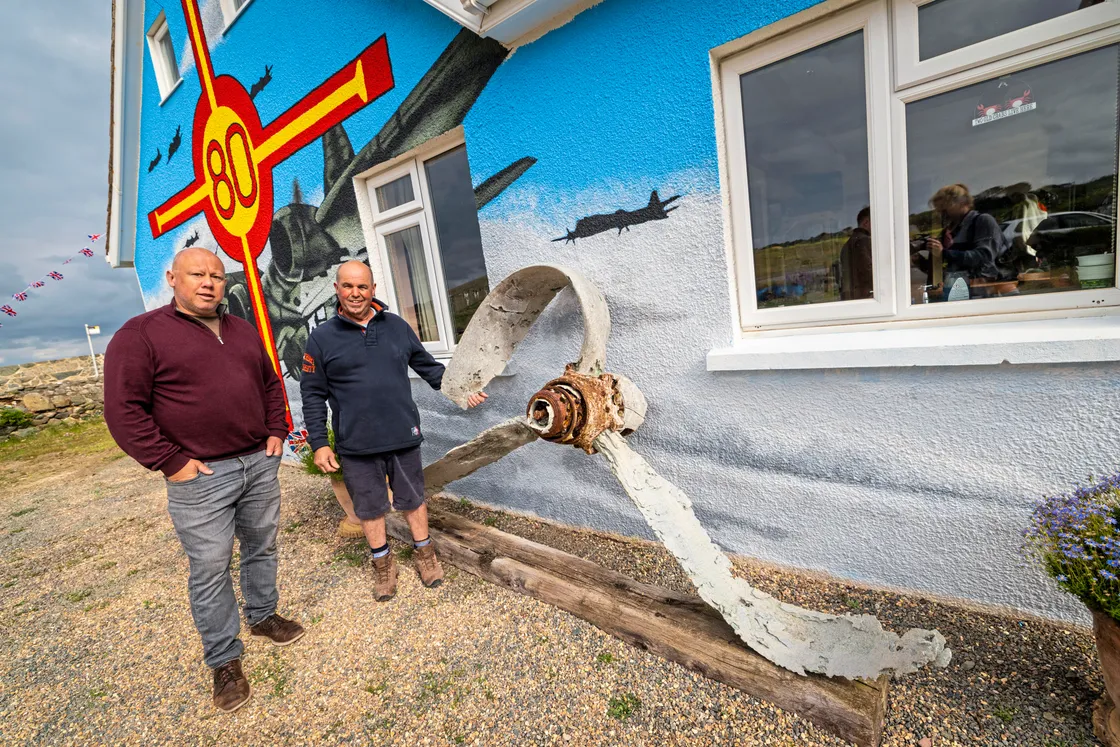 A propeller from a B-17 that Mr Le Noury found while out fishing in 2014 takes pride of place next to the artwork.