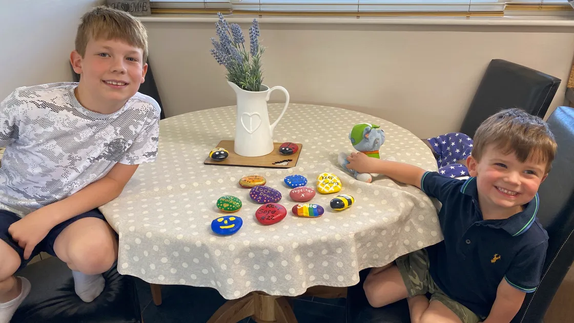Cody Lowe, aged 8, with his brother Freddy, age 3, and their colourful painted pebbles. (28068963)